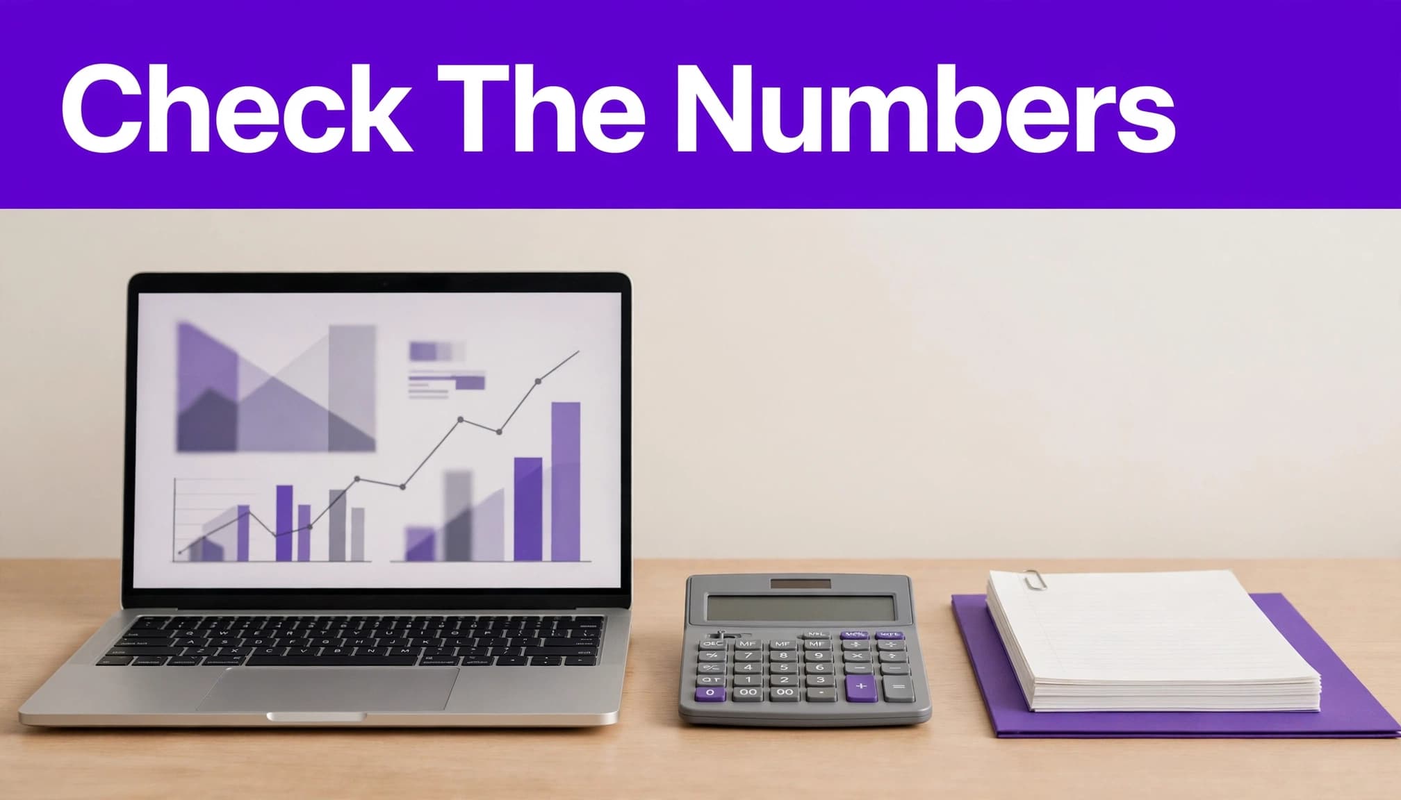 Laptop with abstract charts, calculator, and organized notes on a modern desk.